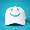 White cap with teal smile