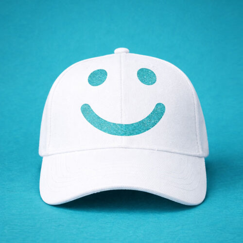 White cap with teal smile