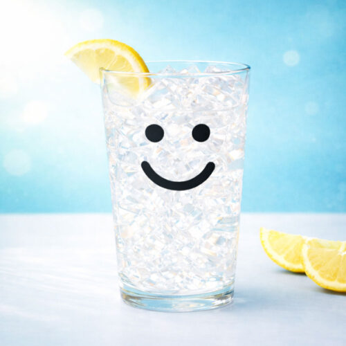 Iced glass with black smile and lemon