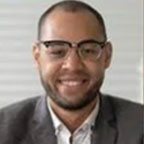 Man in suit wearing glasses smiling