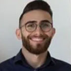 Bearded man wearing glasses and smiling