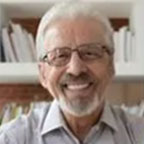 Older man wearing glasses smiling